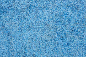 Fototapeta na wymiar Background of blue terry fabric with light stains
