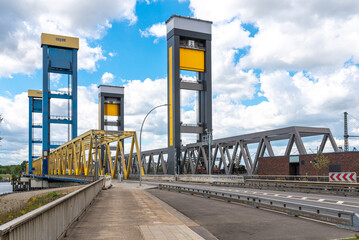 The Kattwyk Bridges, a pair of vertical-lift bridges in Hamburg, have a lift span 100 m long, one...