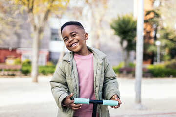 Little boy in the park in scooter