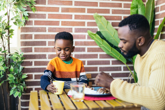 Father and son eating on the terrace
