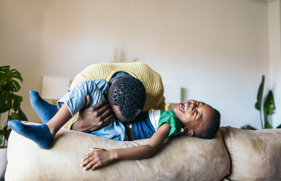 Father playing with his son at home