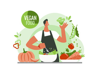 Vegetarianism, a vegan man cooks food. Vegetarian food, vegetables, greens, lettuce, carrots, peppers, cabbage. Healthy eating.