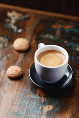 Cup of coffee with Amaretti (Italian biscuits) on rustic wooden background. Copy space.                                                                                                                 