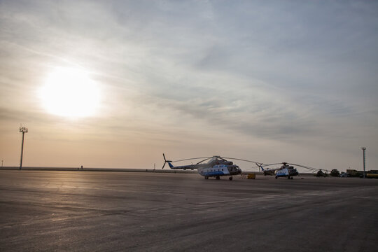 Aktau, Kazakhstan - May 21, 2012: International airport Aktau. three helicopters on nice blue sky with clouds background.