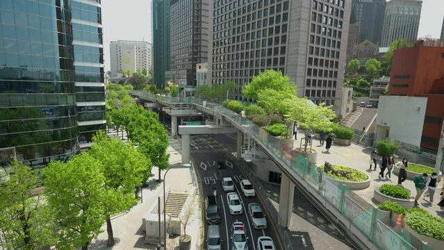 Group of tourist in masks walking on Seoullo 7017 skygarden park in Seoul - top view