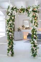 Arch with artificial flowers in the room