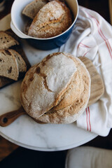 round freshly baked bread top view. sourdough bread is on the table. whole and sliced bread.	
