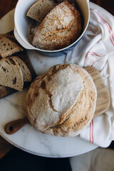 round freshly baked bread top view. sourdough bread is on the table. whole and sliced bread.