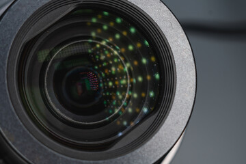 A small ordinary camera with a built-in zoom lens. Close to the glass. Glare and details. The...