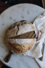 freshly baked craft bread on a white marble table. sourdough bread. craft sourdough bread macro photo.