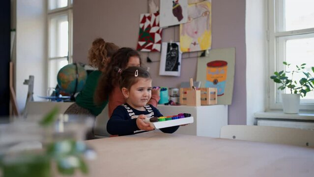 Happy little children preparing for art and craft class indoors at school