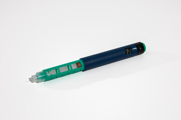 Insulin pen with needle tip isolated on white background. Medical devices is used to self-injection for treatment diabetes disease.