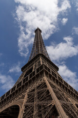 sight of Eiffel Tower in Paris against blue sky with white clouds