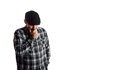 Man with doubtful and pensive attitude. Person with beret and plaid shirt on white background