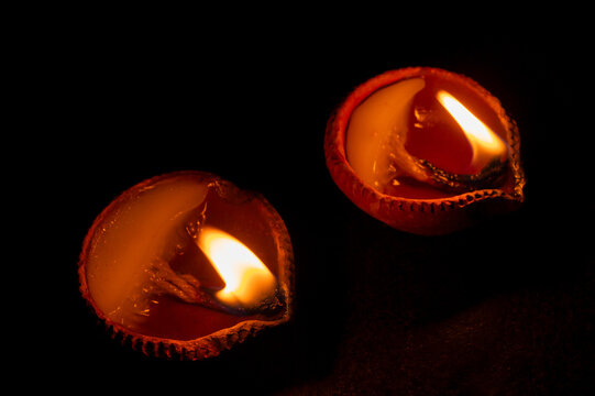 Side view of candles or diyas, Deepawali lights at night. Dark background stock image.