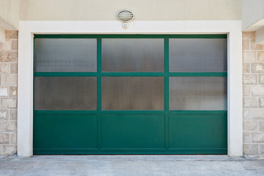 Green glass garage door in a private house