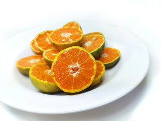 Fototapeta na wymiar Fresh oranges on the plate isolated on white background