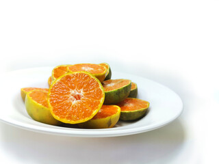 Fototapeta na wymiar Fresh oranges on the plate isolated on white background