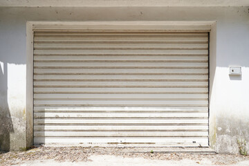 Facade of an uncleaned garage with gray gates