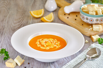 Tasty and healthy dietary food. Pumpkin soup cream on a white