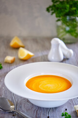 Tasty and healthy dietary food. Pumpkin soup cream on a white