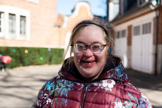 Close up outdoor portrait of a 39 year old white woman with Down Syndrome