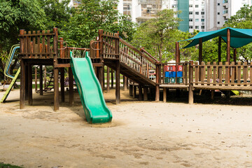 Tunnel and slider, rustic and colorful playground for children in the park, children's corner. Recreation area