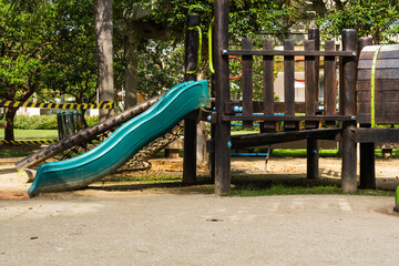 Tunnel and slider, rustic and colorful playground for children in the park, children's corner. Recreation area