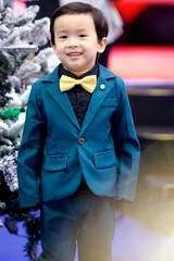 Merry Christmas boy  dress up green suit for Christmas celebrations.