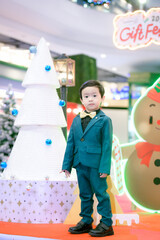 Merry Christmas boy  dress up green suit for Christmas celebrations.