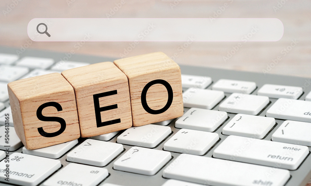Fototapete the word seo search engine optimization written on wooden blocks on a white computer keyboard.