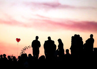 Fototapeta premium Silhouettes of people with different expressions on the embankment of the sea sunset.