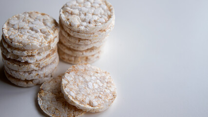 stack of mini puffed rice pancakes on white background