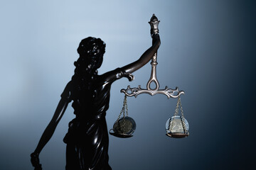 Silhouette of statue of goddess of justice Astraea with mechanical weighing scale and Euro money as...
