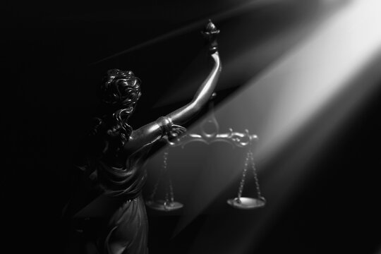 Daughter of Zeus and Themis virgin goddess of innocence and purity Astraea (Astrea, Astria) with mechanical weighing scale of truth and justice. Silhouette of statue.