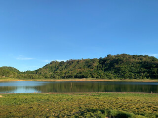 Landscape of water reflection at reservoir in summer season  in Nakornnayok province, Thailand