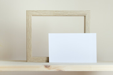 Simple mockup template with wooden frame and white card on yellow background.