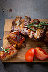 Sliced roasted ribs bbq and tomatoes on wooden boards food