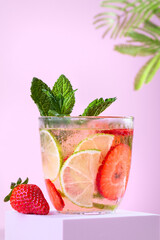 Lime and strawberry refreshing summer infused water on podium