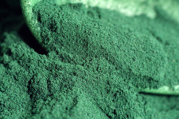 Spirulina algae powder close up. Superfood concept. Macro photography. Selective focus