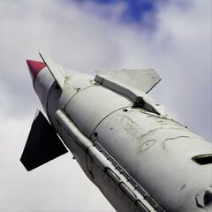 low angle on missile launcher by cloudy sky