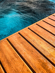 Wooden deck by the pool in close up for background.