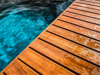 Wooden deck by the pool in close up for background.