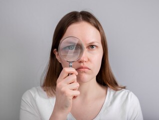 Eye problem, disease concept. Pain, ache and eyesight checking. Woman with magnifying lens. High quality photo