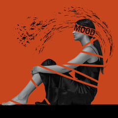 sad and unhappy woman sitting on orange background with a depressive mood. The concept of mental health, communication, mentality, feelings, psychology and advertising