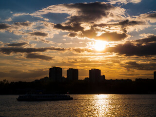 Picturesque View of the city on the river, Against The Sky During Sunset