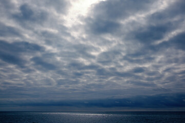 Obraz premium Dramatic stormy dark cloudy sky over sea, natural photo background