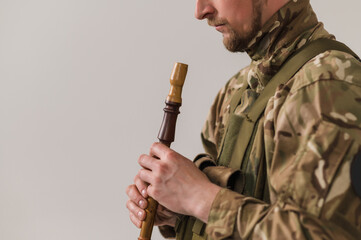 Ukrainian military plays folk songs on a pipe