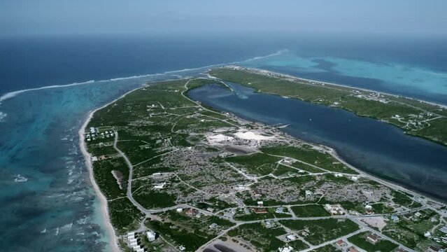 Aerial camera shooting panorama of Cockburn Town, Grand Turk, Turks and Caicos, drone footage of Sargasso Sea coatline

