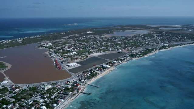 Aerial view of Cockburn Town with saline lake in the middle in the middle of the Grand Turk island, drone panoramic footage of Turks and Caicos
